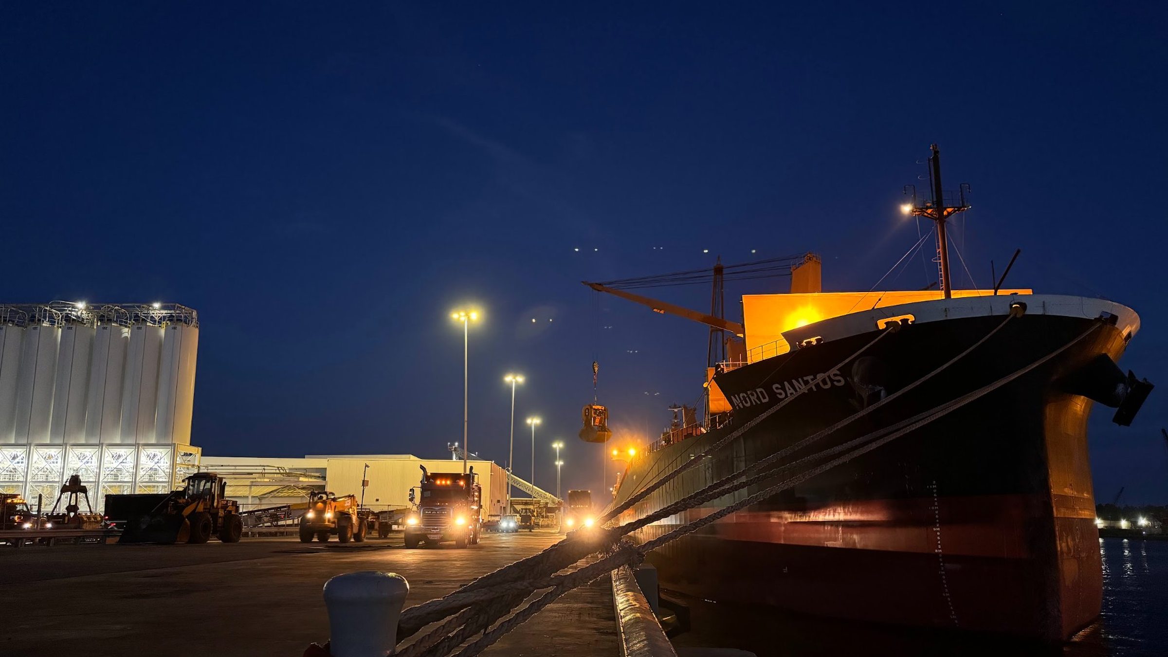 Bulk cargo vessel Nord Santos at port, night operation