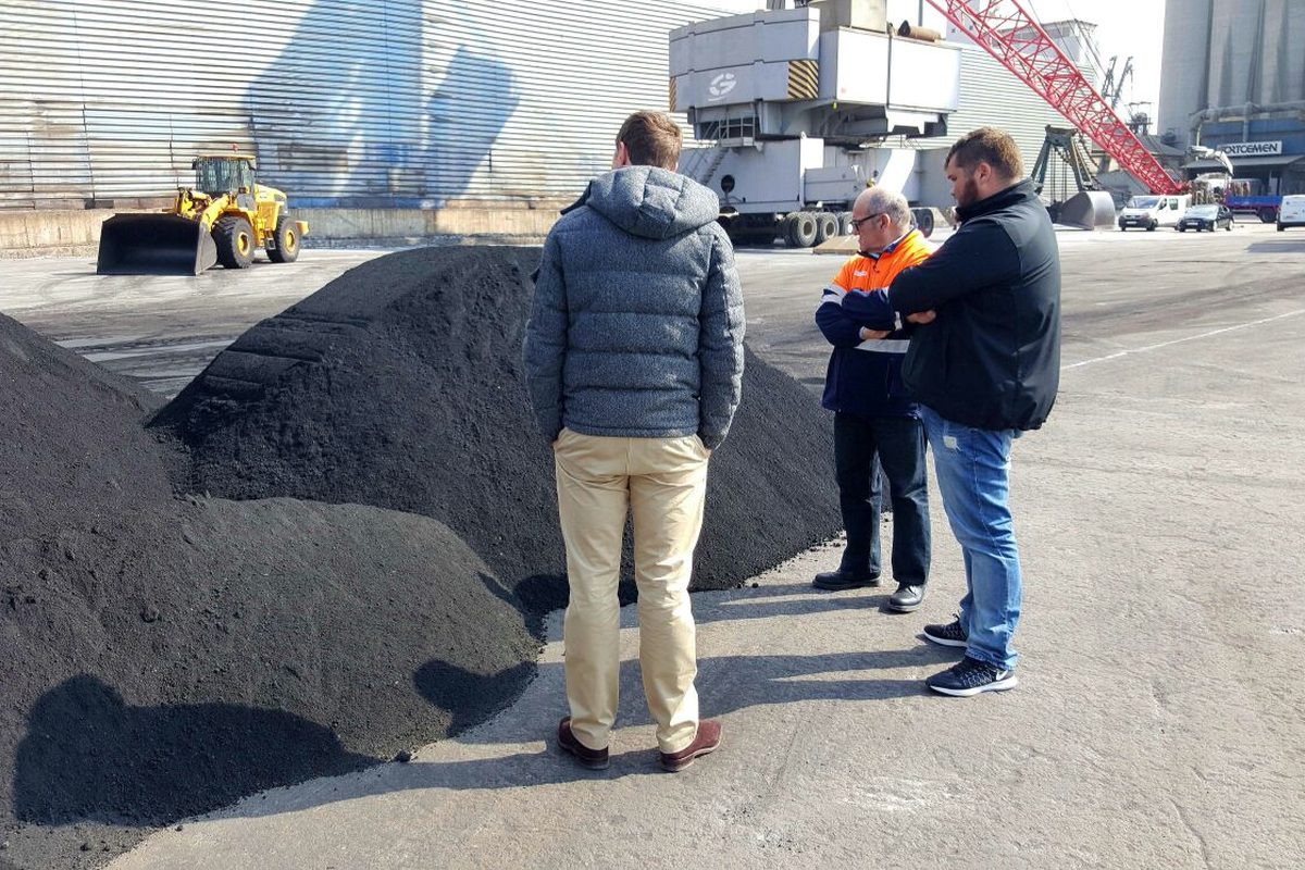 Trident team with supplier contact reviewing cargo at origin port